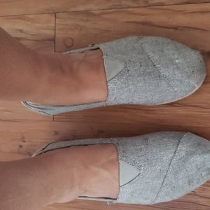 TOMS slip ons in light grey.